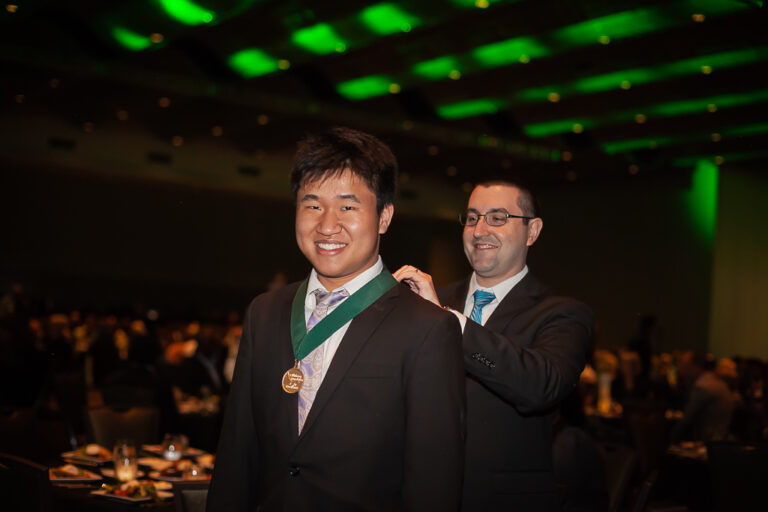 Academic All-State honoree Raymond Jiang of Jenks High School receives his medallion.
