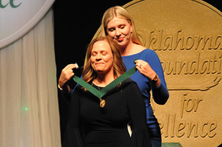 Elaine Hutchison, Medal for Excellence recipient in Secondary Teaching, receives her medal at the 2022 Academic Awards Banquet. Hutchison teaches trigonometry and calculus as well as serving as the academic team coach at Fairview High School.